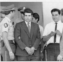 Juan Corona, in the center seen leaving the hospital for an EKG. He is an accused mass murderer