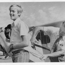 Instructor Glen Engle, in a ceremony familiar to many thousands of fliers, cuts off Bob Hitch's shirttail after he soloed for the first time