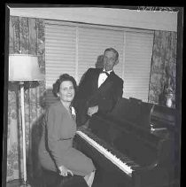 Unidentified woman sitting at a piano