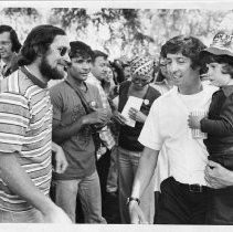 Tom Hayden (Thomas E. Hayden), antiwar and civil rights activist, speaking to voters in Capitol Park, Sacramento. He is holding his son with Jane Fonda, Troy Garity. He was a candidate for U.S. Senator from California (Democratic primary)