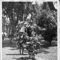 Exterior view with Genevieve and Frank Didion of the Native Sons and Daughters of the Golden West at Camellia Grove, in Capitol Park