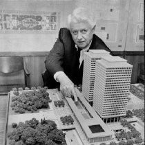 Senator Randolph Collier examines model of Twin Towers office building