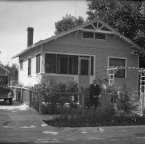 Couple standing in front of residence