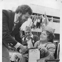 Paul Martin, March of Dimes poster child and a member of the Wheelchair Brigade, receives a resolution from Aaron Barger of the Sacramento Metropolitan Chamber of Commerce