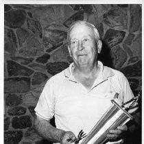R. C. Brick Eldred shown holding golf trophy