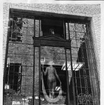 Exterior view of the bronze statue by Edward Field Sanford, Jr. above the third floor of the State Library and Courts Building. The statue is mounted in the decorative windows above the entrance to the building