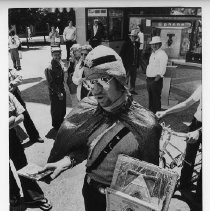 Barry McArdle, street performer, in a costume with turban and cape, selling real estate on the moon