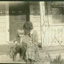 Mother and child seated on porch steps