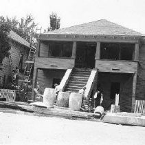 Workers renovate two houses