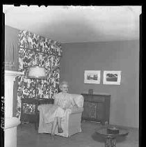 A woman seated on an arm chair