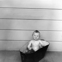 Unknown child in tub outdoors