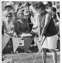 Betty Hicks, a former golf professional who was Women's Athlete of the Year in 1941, gives some brief pointers before trying for an ice in the Mercy Children's Hospital Guild's Hole-in-One Contest at the Perkins Golf Center