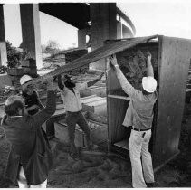 State crews unpack crates holding items that will not be used in the California State Capitol restoration project