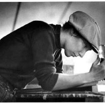 View of an artist working with a chisel on the wood carvings for the ...