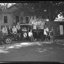 A group of men standing on a truck with a pony