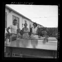 People standing next to a ping pong table