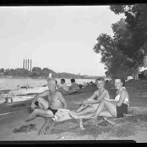 Sunbathing on a river beach