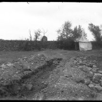 View of a miner's tent set in dredger tailings