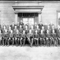 Men posed in front of the Southern Central Pacific Railroad shop offices