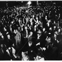A huge crowd holds a candlelight vigil at Plaza Park in memory of John Lennon