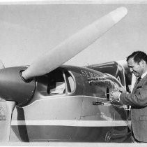 Dr. Alvin Marks, pilot and owner of Skymark Airlines. Here, Marks checks the oil level of his Cessna