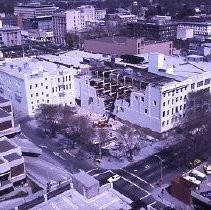 Views of redevelopment sites showing the demolition of buildings and reconstruction in the district. View of the Downtown Plaza and the demolition of Breuner's Furniture Store at 6th and K Streets