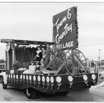 Town & Country Village sign on a parade float