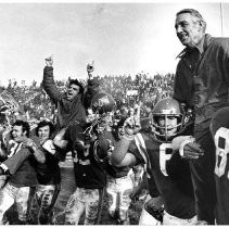 Louisiana Tech Coach Maxie Lambright, right, and his aides are given a victory ride by their players [at Camellia Bowl]