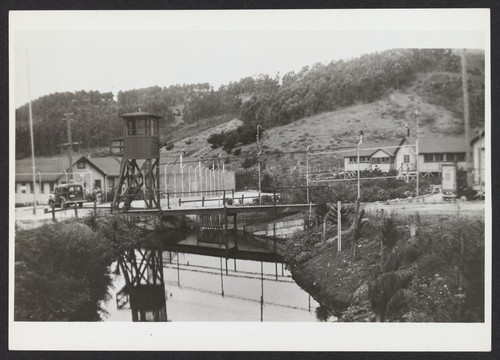 [guard tower and exterior of fence showing creek]