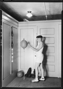 Boy at punching bag, Christmas topics, Broadway Department Store, Los Angeles, CA, 1925