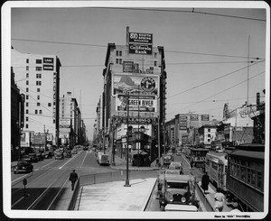 Looking north at the point at which Main Street and Spring Street separate as trolleys cars and cars clutter the street