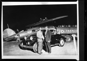 Composite of Mark Hanna, Hollywood Dodge dealer, and Captain Frank Hawks, the night he arrived from New York, Metropolitan Airport