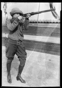 Miss Winter shooting at leopard, Southern California, 1928