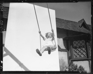 Little girl in swing, Marilyn Bourne, Southern California, 1934