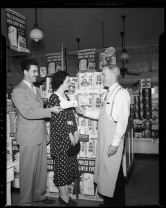 Presenting check to manager of Shop N' Save Market, San Gabriel, CA, 1940