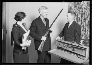 Presenting gun to Mr. Barneson, Southern California, 1930