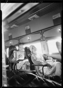 Reading Time magazine in plane, Southern California, 1929