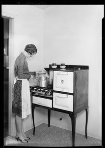 Housewife at stove, Southern California, 1928