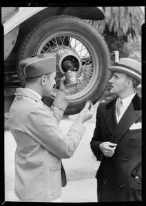 Young man watching greasing of car, Union Oil Co., Southern California, 1931