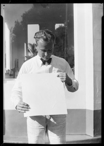 Man holding ad, Union Oil Co., Southern California, 1931