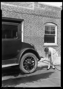 Girl with brush under the car, Southern California, 1926