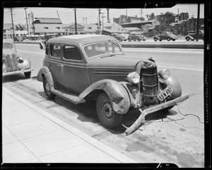 1937 Plymouth coupe, (assured), 1935 Dodge sedan, and skidmarks at 20th Street & Long Beach Avenue, Los Angeles, CA, 1940