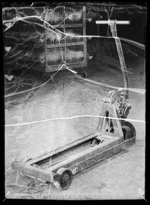 Scales, dolly and crates in chicken department of Young's Market Company, Southern California, 1936