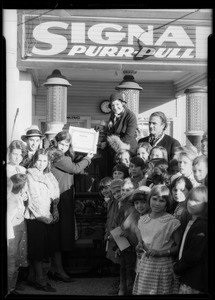 Fargan presenting radio to boy, Southern California, 1933