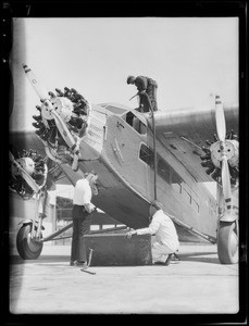 3/4 view plane for Clarkson Dye, artist also loading gas in plane, Southern California, 1929