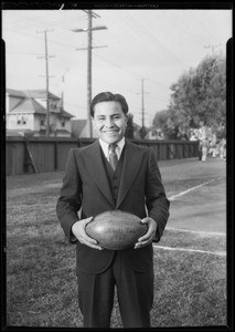 Boy with autographed football & Captain Brown, Southern California, 1932