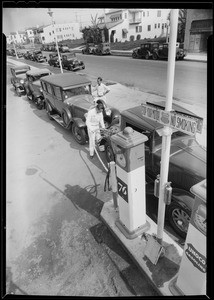 Line up of cars at 76 pump, West 3rd Street & South Detroit Street, Los Angeles, CA, 1932