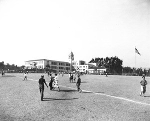 Photo of a soccer match on the school playground, looking out northwards over the city