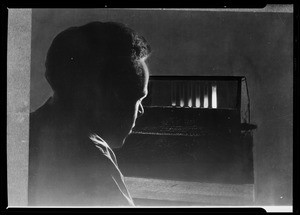 Composite of man looking at test tubes, Southern California, 1936