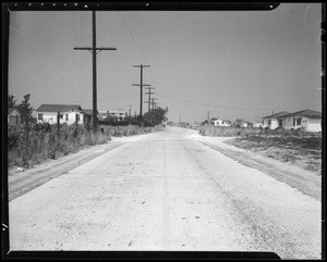 Wrecked 1937 Chevrolet sedan and 1938 Ford sedan and intersection of Winona Avenue and North Ontario Street, Southern California, 1940